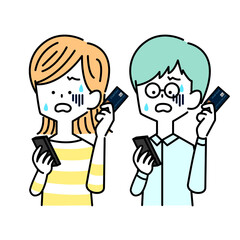 困惑してスマホとキャッシュカードをもつ男女