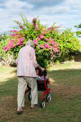 Elderly lady going for a walk in garden to stay healthy