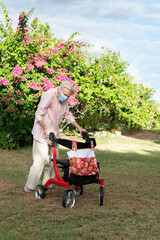 Elderly lady going for walk in garden to stay healthy