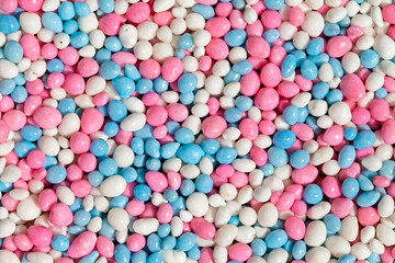 Close up of blue, pink and white glazed anise seeds, called 