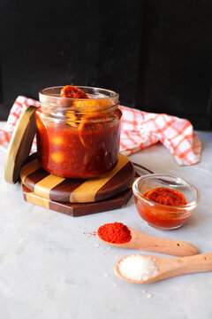 Indian traditional homemeade sweet, tangy and spicy lemon pickle or limbu che lonche. also known as Nimbu ka Achar in hindi. recipe ingredients at background along with copy space.