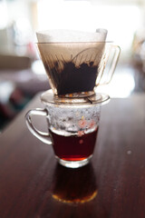 Instant freshly brewed cup of coffee or paper dripping bag on a cup.