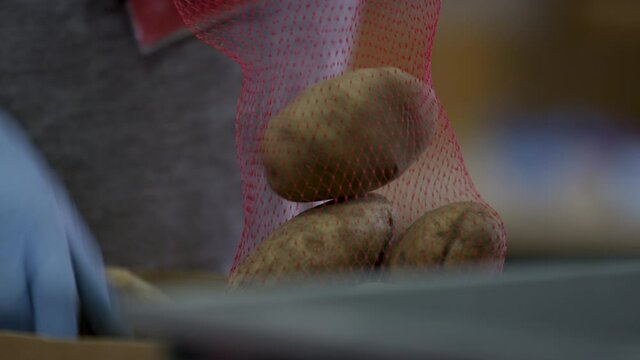 Potatoes getting baged at a food bank for people in need during the COVID-19 pandemic
