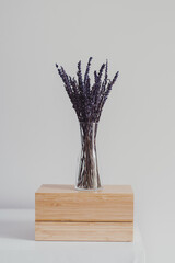 Vase with dried lavender on top of wooden jewelry box. Simple scandinavian interior details. Home...