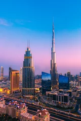 Foto op Canvas Downtown Dubai during amazing purple sunset with the world's tallest building, the world's largest mall and adjoining luxury hotels © Captured Blinks