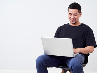 Young man sitting work with laptop.