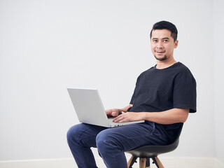 Young man sitting work with laptop.