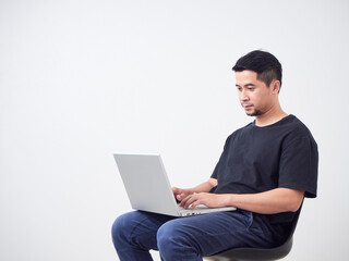 Young man sitting work with laptop.
