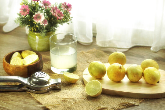 healthy drink concept fresh lemon juice with squeezer served on table top
