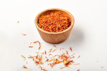 Iranian red saffron spice in wooden bowl isolated on white background