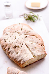 Homemade fresh baked Fougasse (French Bread) with thyme and olive oil on white background. Traditional Provencal dishes. Selective focus