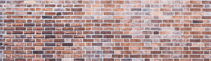 design backdrop. Panoramic background of wide red, yellow and brown brick wall texture.