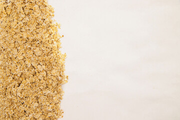 Oatmeal flakes scattered on a white background. Dietary food. Healthy breakfast.Texture and background.
