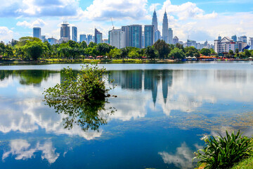 Reflection of Kuala Lumpur City Centre on Titiwangsa Lake Garden. - obrazy, fototapety, plakaty