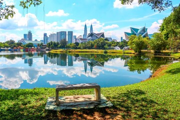 Reflection of Kuala Lumpur City Centre on Titiwangsa Lake Garden. - obrazy, fototapety, plakaty
