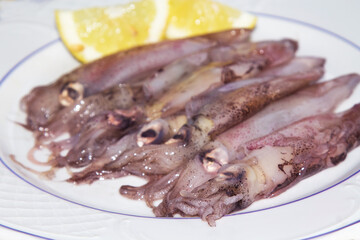 fresh squid or cuttlefish with lemon on the plate