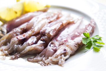 fresh squid or cuttlefish with lemon on the plate