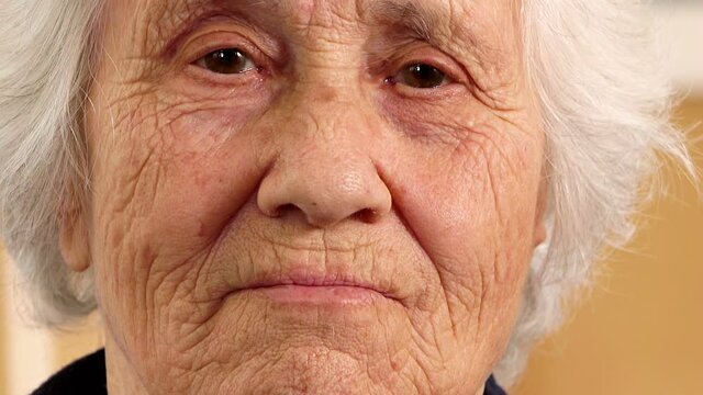 Serious old woman stares the camera