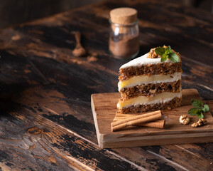 piece of carrot cake on a brown wooden background. Rustic style, place for text