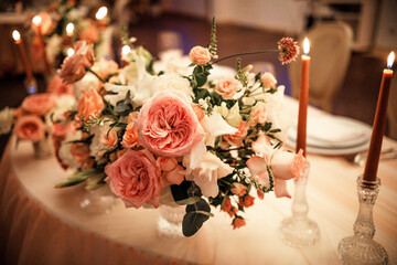 The wedding table is decorated with flowers and candles.