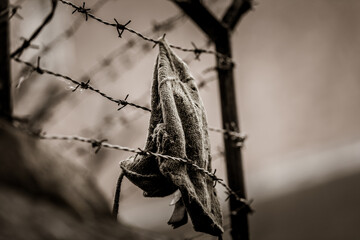 un cappello di lana è incastrato nel filo spinato
