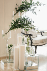 interior of a hotel room. candles and green plants in glass vases