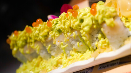 Close up Sushi rolls with cheese topping