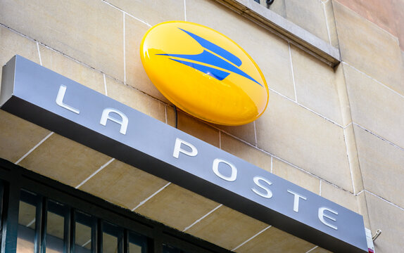 Paris, France - October 18, 2018: Low angle view of the sign of La Poste company, the french postal service public company, on the facade of a building above the entrance of a post office.