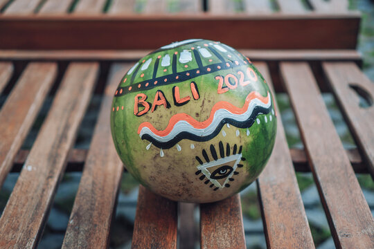 watermelon with the eye of providence symbol in a triangle and with the inscription bali 2020