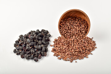 Raisins and grape seeds isolated on white background