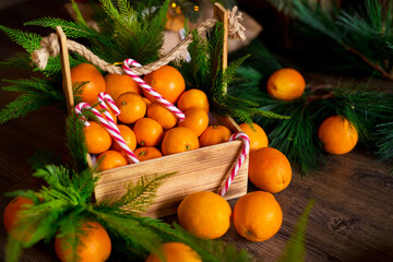 Christmas gingerbread cookies, tangerines, branches of a Christmas tree with garlands on a wooden background. A Christmas background with space for text. Happy Christmas morning.