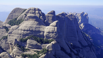The rocky peaks of the mountains rise above the valleys of the province of Barcelona.