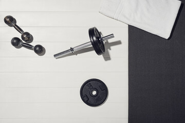 Obraz na płótnie Canvas Sport equipment on white wooden background, training at home concept.