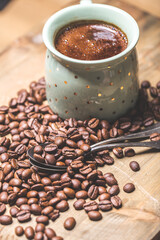coffee cup and coffee beans on old wooden table. Vintage style