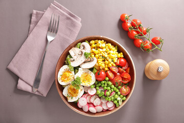 Fototapeta na wymiar buddha bowl- vegetable salad with egg, mushroom, corn and tomato