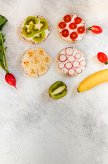 Vegetarian food cereals with curd cheese, cherry tomato slices, radish, kiwi, banana and cherry. A...