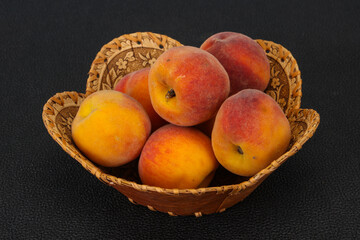 Peach heap in the wooden basket