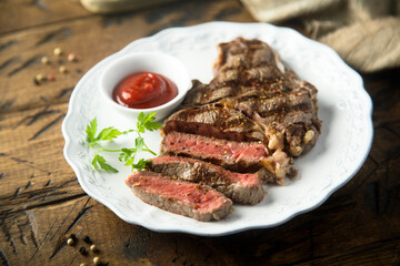 Grilled beef steak with tomato sauce