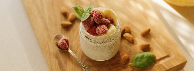 Vegan Chia Pudding with Frozen raspberry, Banana and almond on w