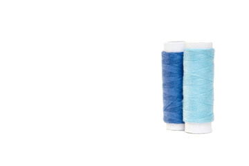 Blue and blue sewing threads on a white background.