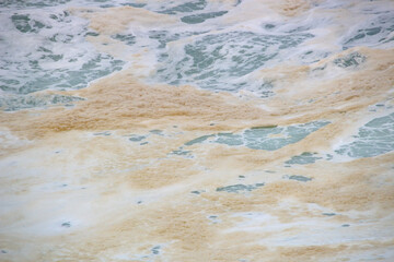 yellow foam from a wave at leblon beach in Rio de Janeiro.