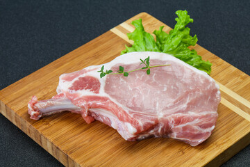 Raw pork bone steak over wooden