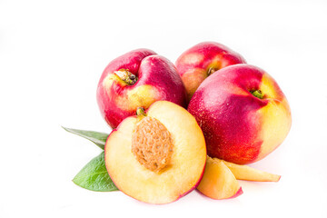 Fototapeta na wymiar Raw whole and half sliced peaches. Fresh summer peaches fruits isolated on white background