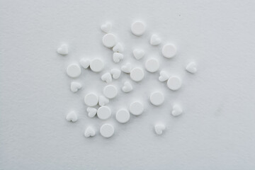 Many pills and tablets on white background