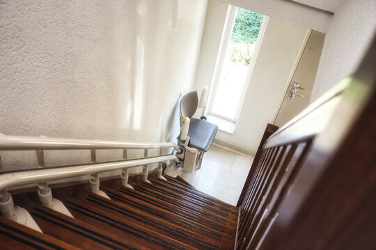 Automatic stairlift on staircase for elderly or disability in a house,