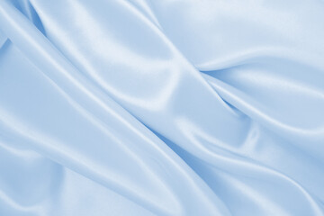 Smooth elegant blue silk or satin luxury cloth texture as abstract background. Luxurious background design