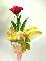 Exotic fruits in a glass with ice cream.