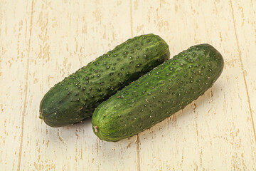 Green fresh cucumbers over background