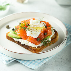 Poached egg with salmon and avocado on toast