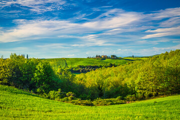 Landscape with farmhouses in Val d'Orcia region of Tuscany in spring time, Italy.